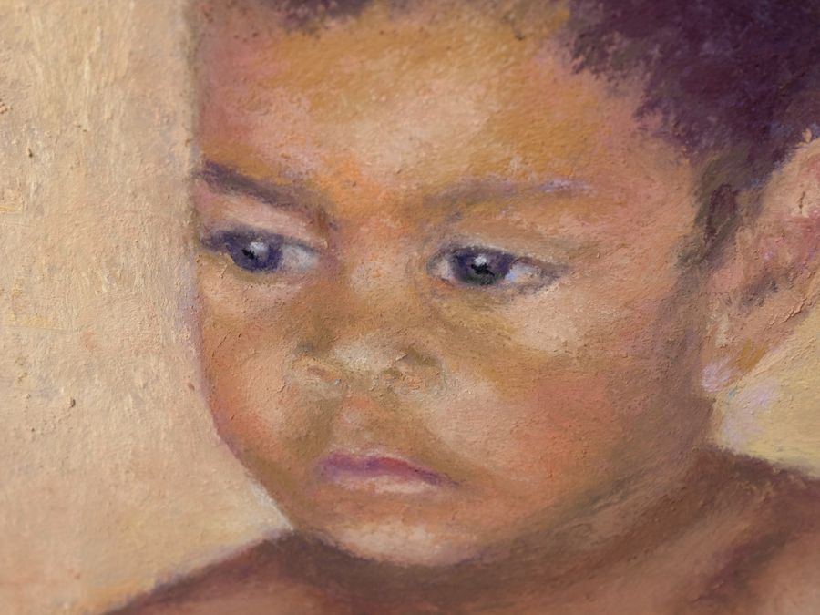 Indigenous boy painting- very close up of face